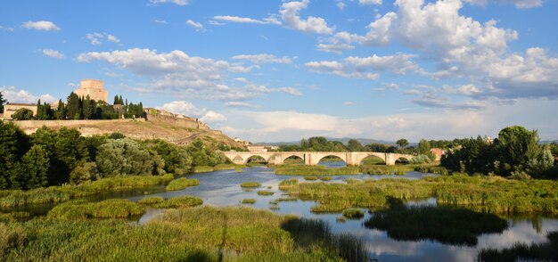 View of bridge and the Castle of Henry II of Castile (14th century) and River Agueda, Ciudad Rodrigo, Castile and Leon, Spain