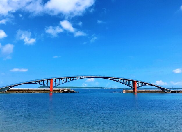 View of bridge over river against blue sky