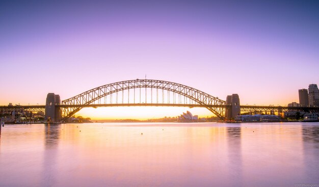 View of bridge over river at sunset