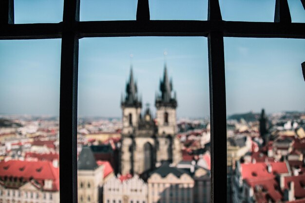 View of buildings against sky seen through window