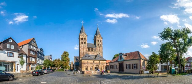 View of buildings and church against blue sky in town