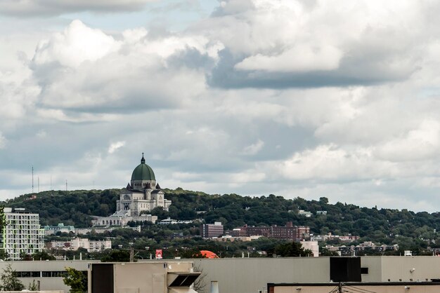 View of buildings in city against cloudy sky