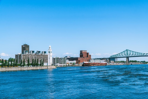 View of buildings at waterfront against blue sky