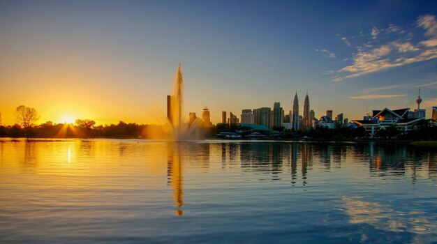 View of buildings at waterfront during sunset