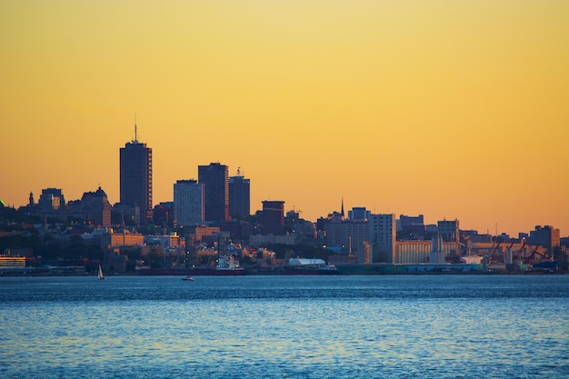 View of buildings at waterfront during sunset