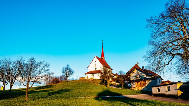 View of built structures against clear blue sky