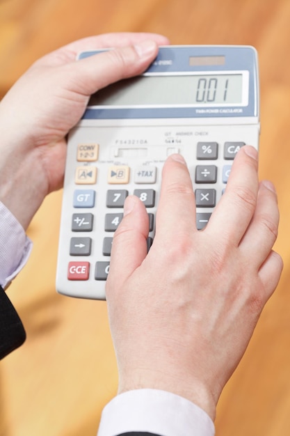 Above view of calculator in male hands