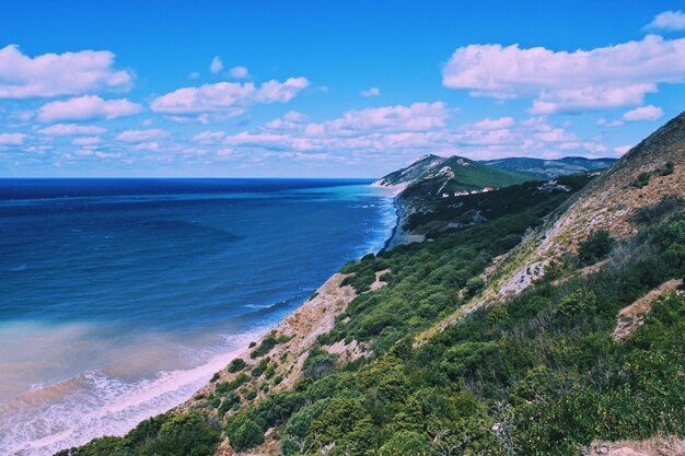 View of calm beach against blue sky