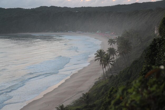 View of calm beach against mountain range