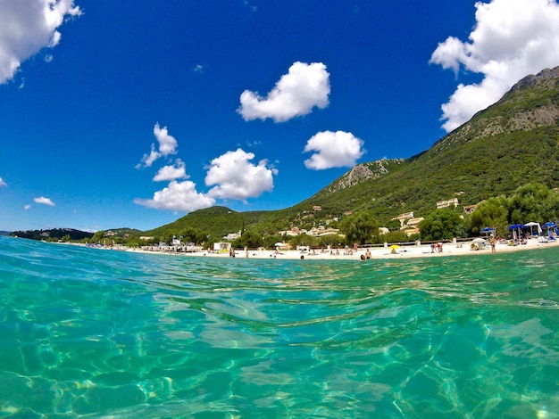 View of calm blue sea against cloudy sky