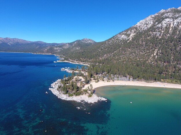 View of calm blue sea against mountain range