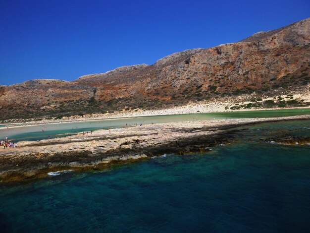 View of calm blue sea against mountain