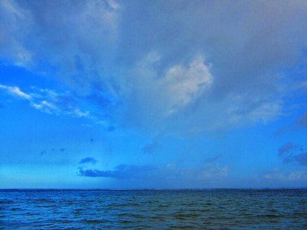 View of calm sea against blue sky