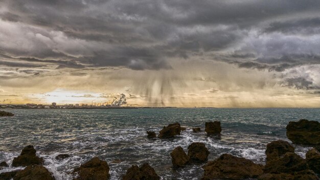 View of calm sea against cloudy sky