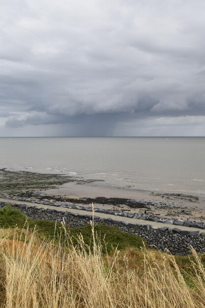 View of calm sea against cloudy sky