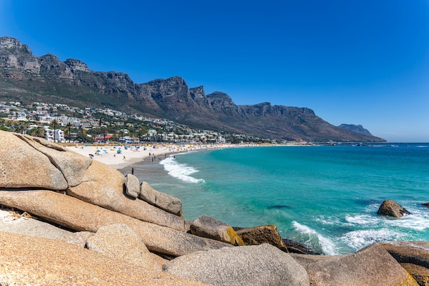 View Camps bay beautiful beach with turquoise water and mountains in Cape Town, South Africa