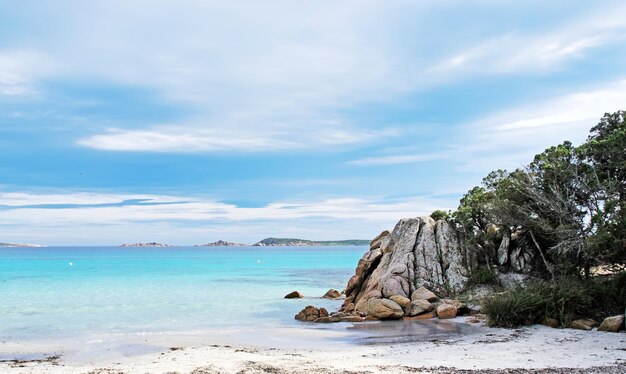 View of Capriccioli beach with rocks on water