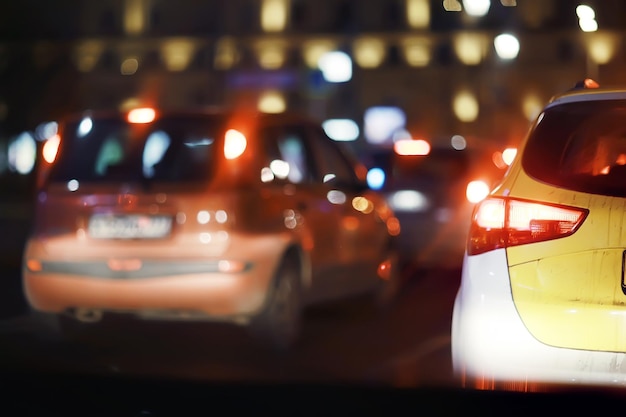 Foto vista dell'auto nell'ingorgo / vista posteriore del paesaggio dalla finestra dell'auto, strada con auto, luci e gambe delle auto vista notturna