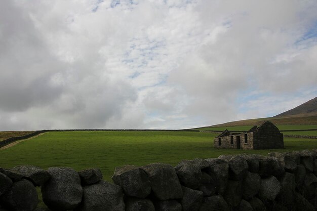 View of castle on landscape against cloudy sky