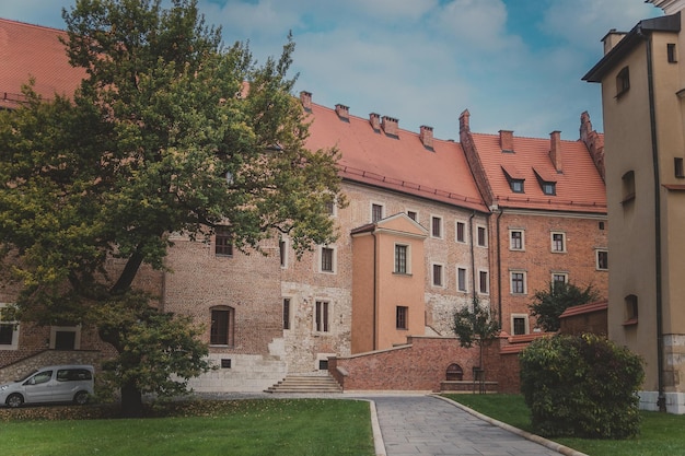 View of Cathedral museum green lawns sidewalk trees and bushes on Wawel Hill