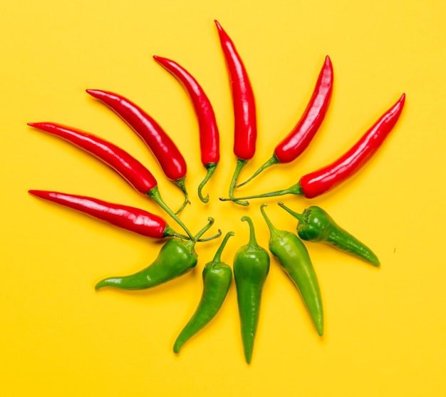 Above view at Chili pepper on yellow background