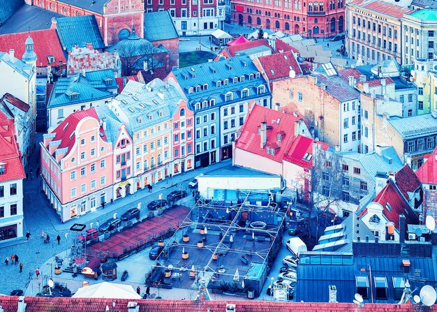 View on christmas market in livu square in riga old town in winter. people on the background