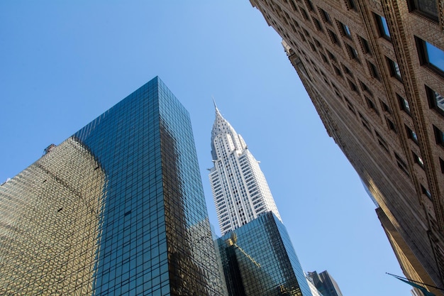 A view of the chrysler building from the sidewalk.