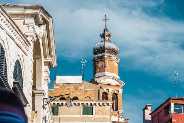 View of Church bell between buildings in Venice Italy