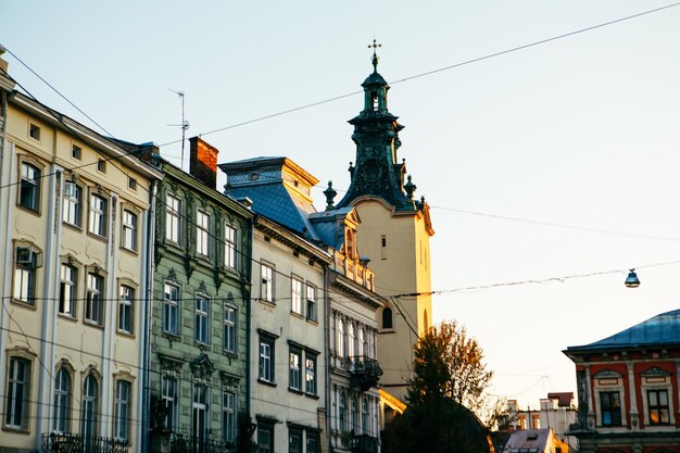 View of city square with church tower on sunset