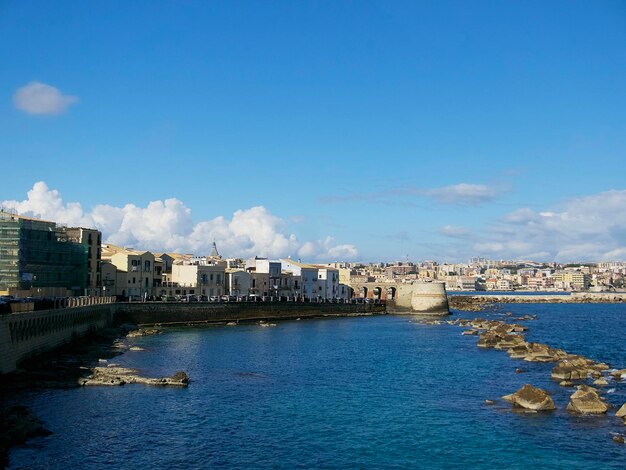 view of the city of Syracuse and the coast of the Ionian Sea on a sunny day in Sicily