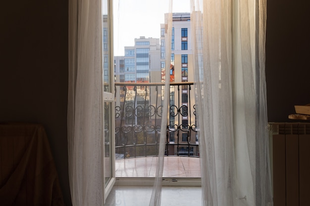 View of the city through the balcony of a chic hotel room.