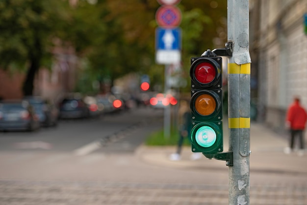 View of city traffic with traffic lights in the foreground a semaphore with a green light closeup