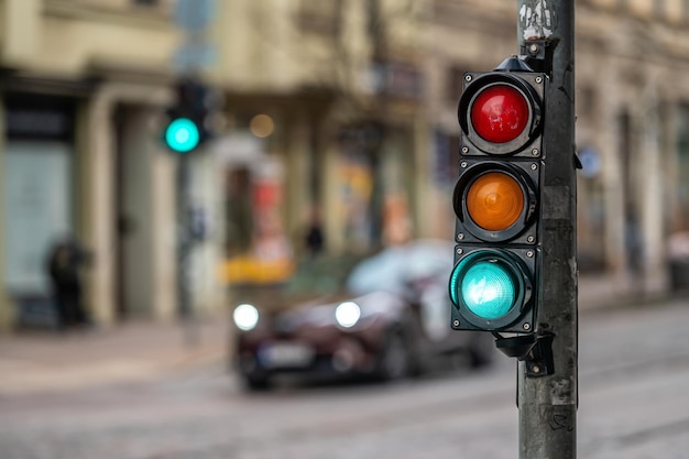 View of city traffic with traffic lights in the foreground a semaphore with a green light closeup