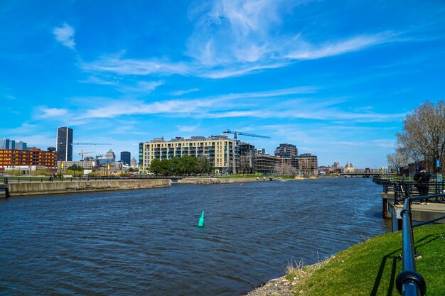 View of city at waterfront against cloudy sky