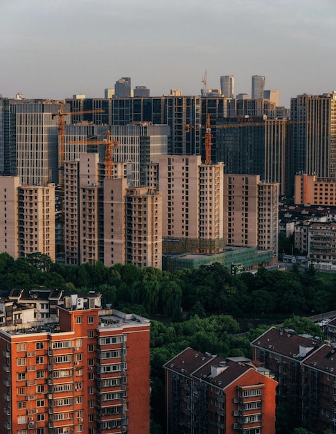 A view of a city with a lot of buildings and a building with a crane on the top.