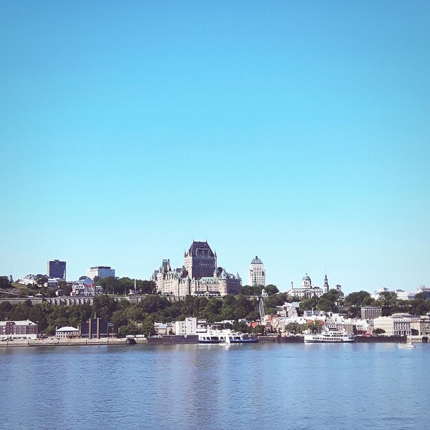 View of cityscape against clear blue sky