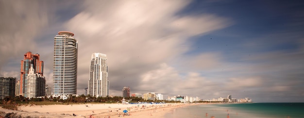 View of cityscape against cloudy sky