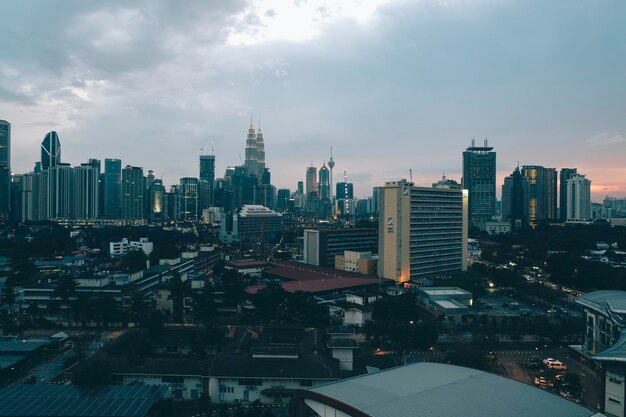 View of cityscape against cloudy sky