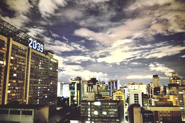 View of cityscape against cloudy sky