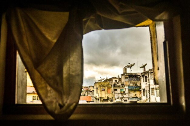 View of the cityscape in berastagi through a window