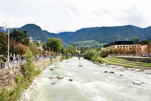 View cityscape and landscape with Italian people and foreigner travelers walking on the bridge crossover passer river at Meran city on September 2 2017 in Merano Italy