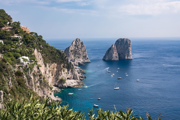 View of cliff coast of Capri Island with famous faraglioni rocks