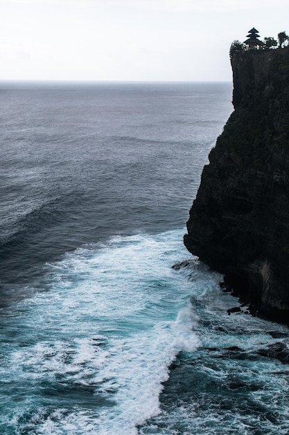 View of cliff and wavy Indian ocean on Bali island