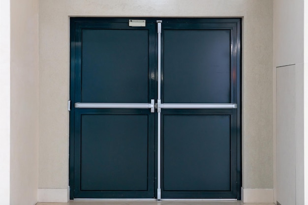 View of the closed door of the evacuation exit from the\
building during a fire or other cataclysm emergency fire exit from\
the building closed emergency exit door for quick evacuation