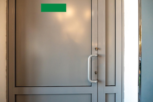 View of the closed door of the evacuation exit from the\
building during a fire or other cataclysm emergency fire exit from\
the building closed emergency exit door for quick evacuation