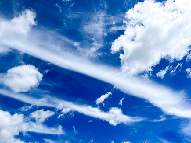 View of the cloudy blue sky. The sun shines through the cloud