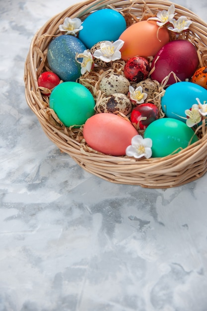 above view colored easter eggs inside basket on white surface spring colourful concept holiday ornate easter