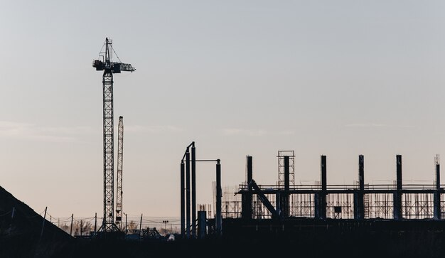 View of the construction site with cranes and high-rise residential buildings.