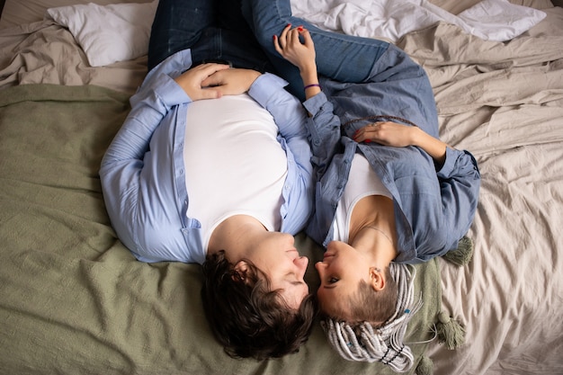 Above view of couple hugging on bed at home