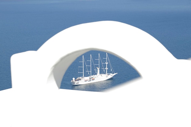 View of a cruise ship through the ornament of a terrace Santorini island Greece